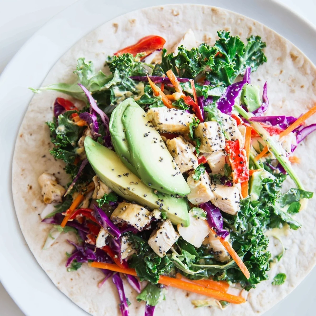 Vibrant Poppy-Inspired Chicken Salad Wraps with crisp veggies and creamy dressing, perfect for lunch.