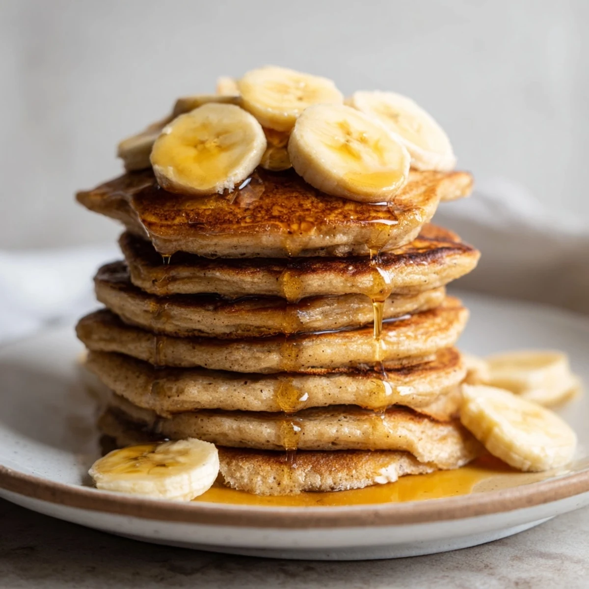 Imagine the aroma: freshly cooked Weekend Golden-Brunch Banana Pancakes topped with sweet maple syrup.