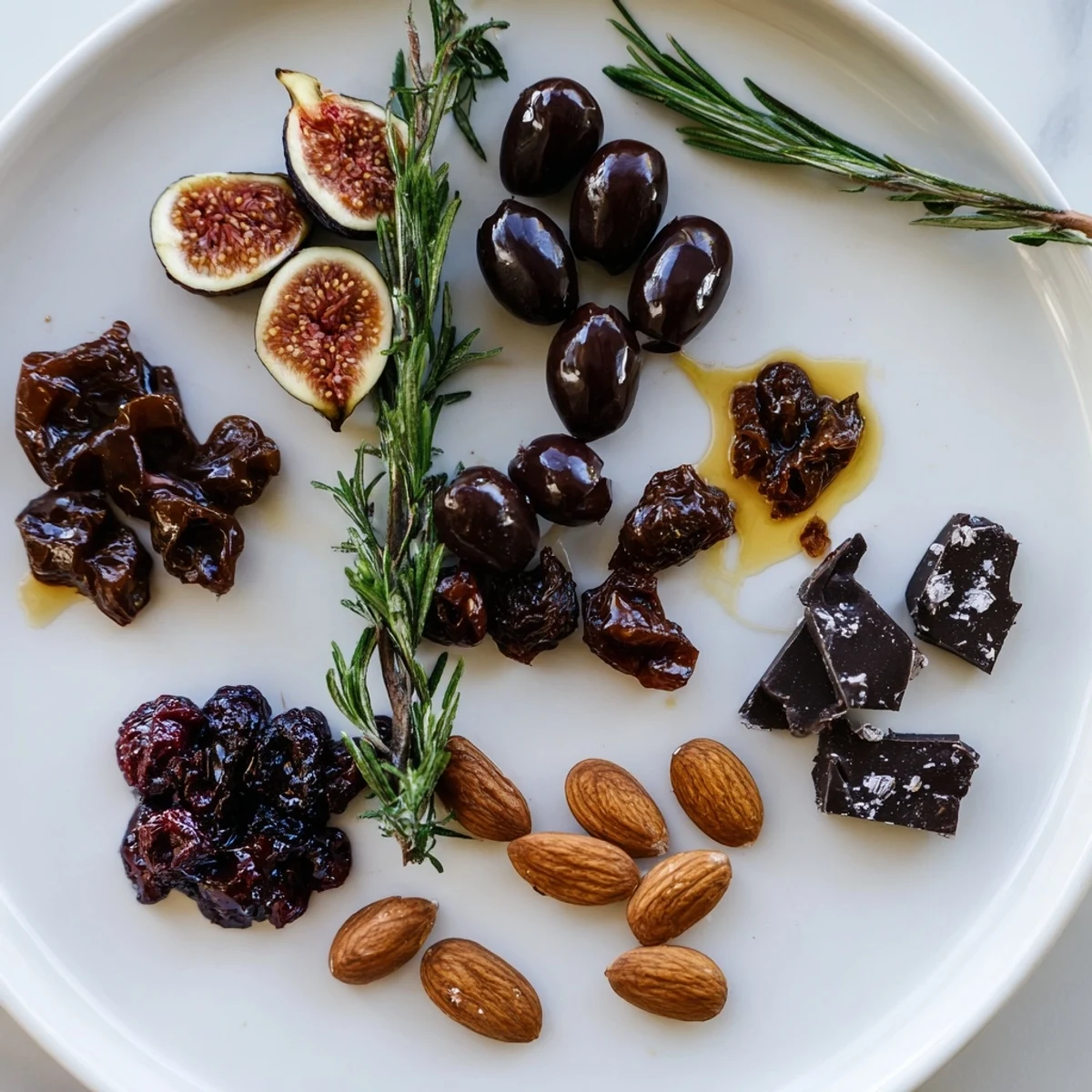 A beautifully arranged Winter Solstice Board, showcasing dark olives, figs, and creamy brie.