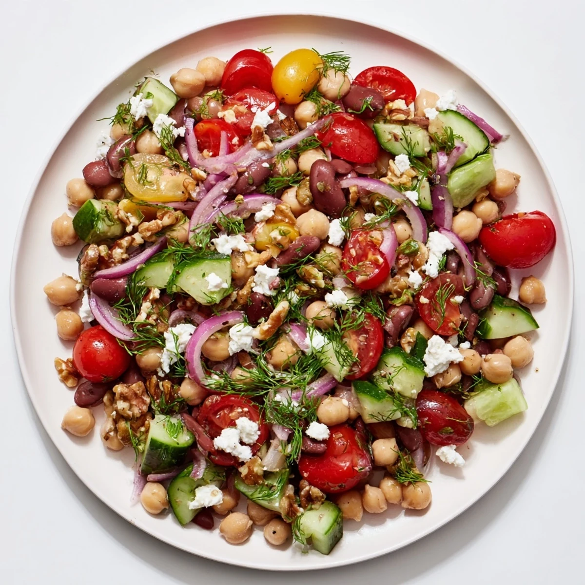 A close-up view of the Dense Bean Salad, featuring colorful veggies and herbed dressing.