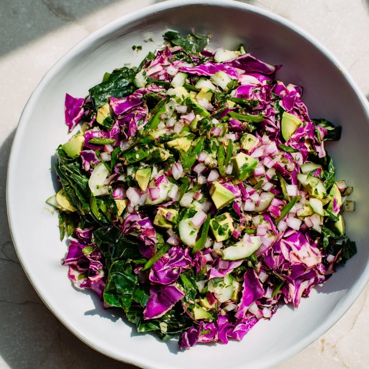 A refreshing bowl of Green Goddess Detox Cabbage Salad, bursting with colorful, fresh ingredients and flavors.