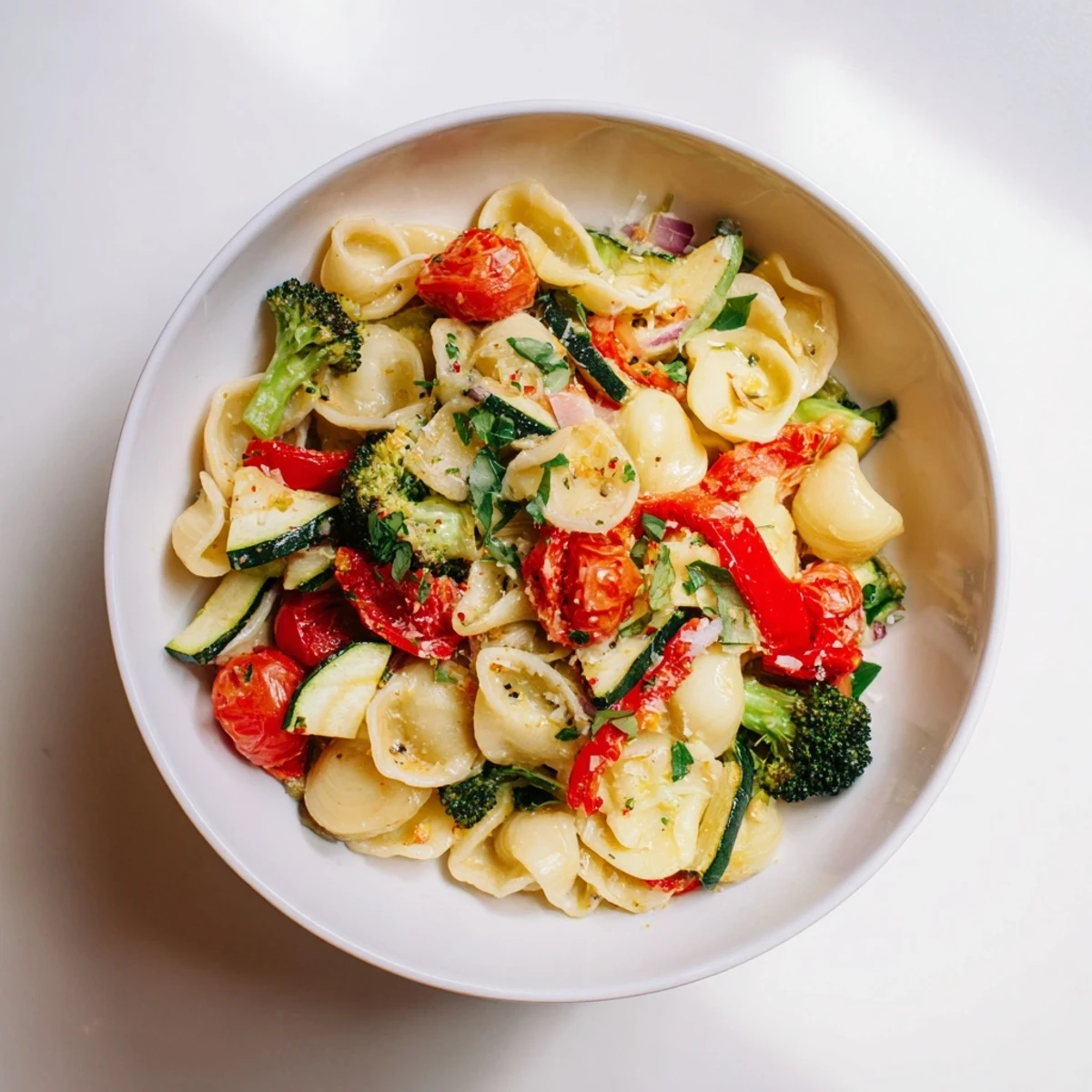 Air-fried ditalini with vibrant vegetables served warm, garnished with Parmesan and fresh herbs.