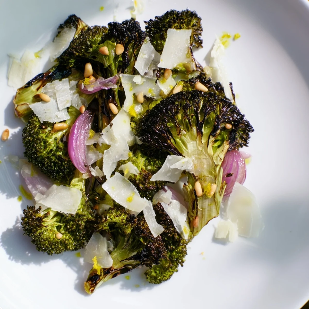 Enjoy a bowl of warm, inviting charred broccoli salad, tossed with perfect Parmesan shavings.