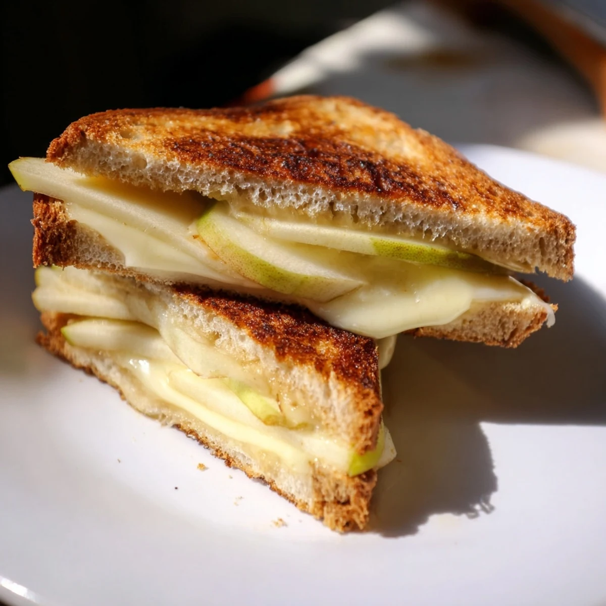 Golden, melted Brie and apple grilled cheese, a warm, comforting sandwich ready to eat.