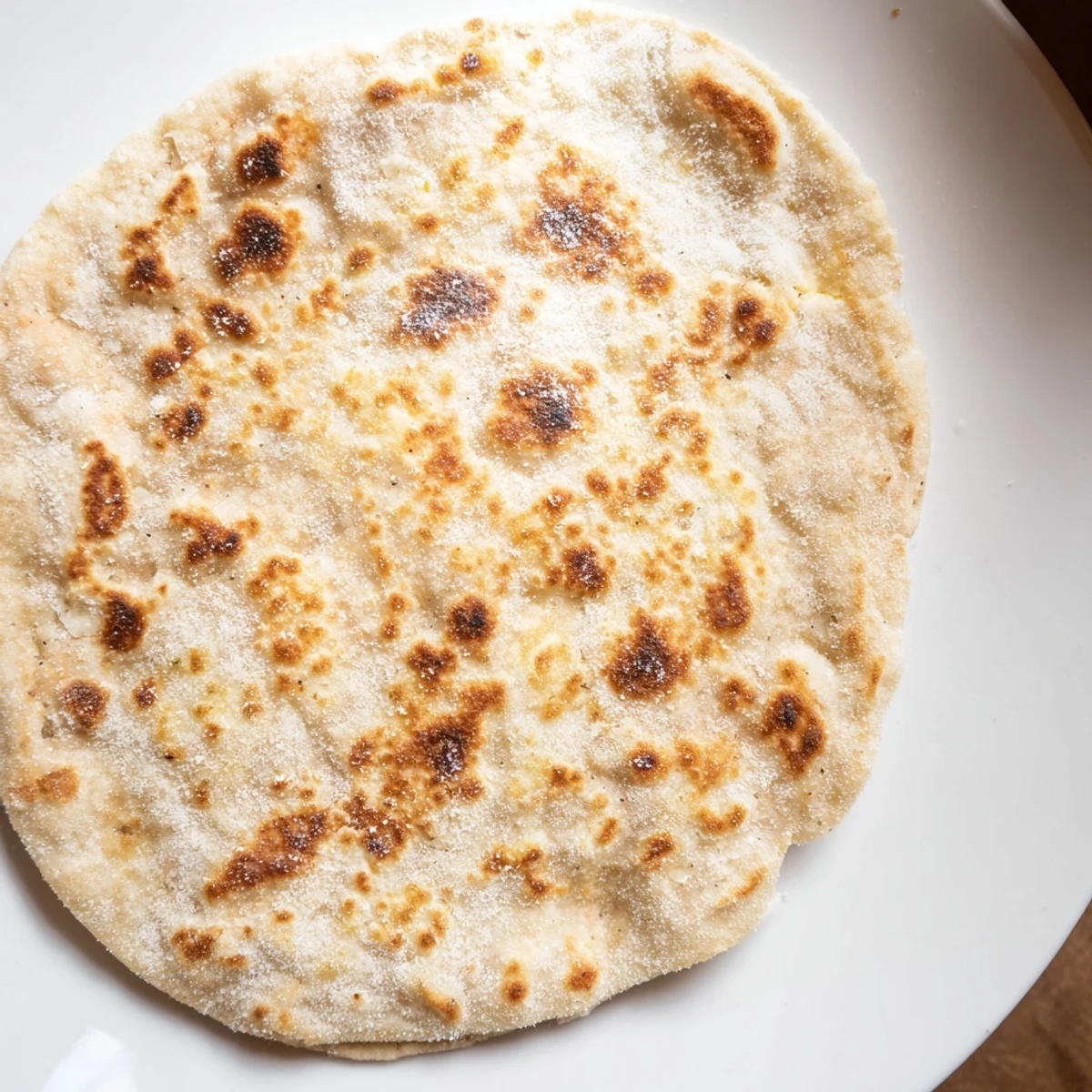 Golden-brown Cottage Cheese Flatbread, lightly charred, ready for delicious savory dips or wraps.