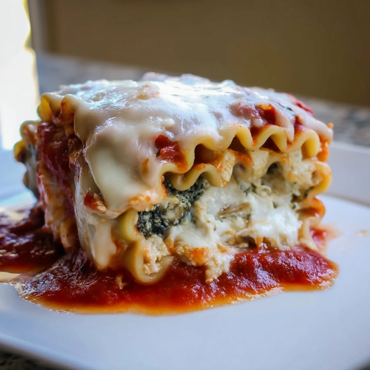 Golden-brown Chicken and Spinach Lasagna Rolls rest in a baking dish, bubbling with marinara sauce and melted mozzarella, garnished with fresh parsley.