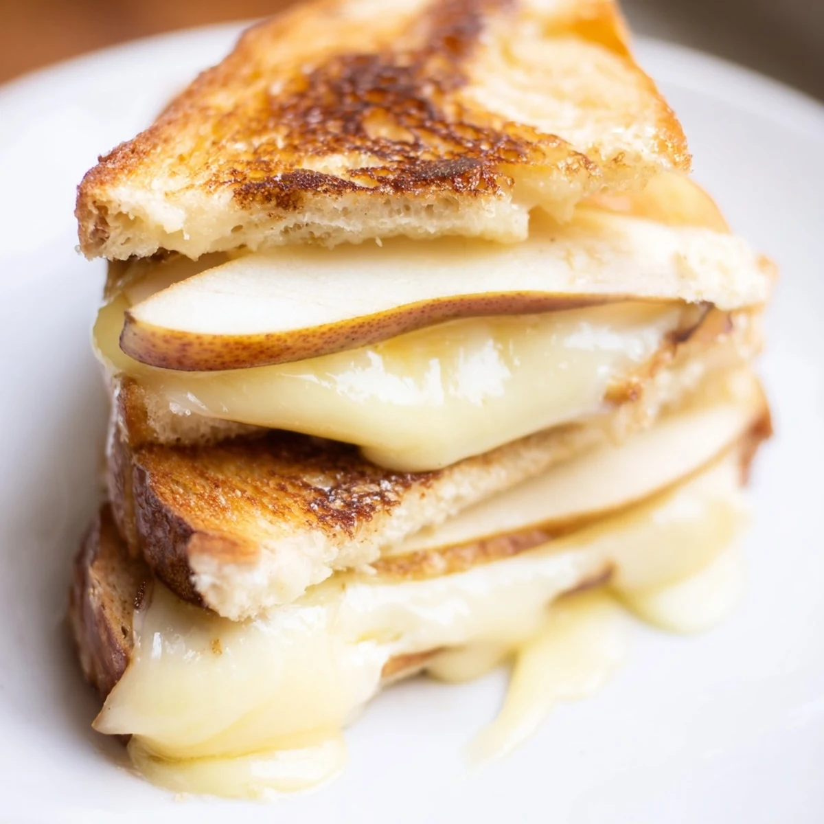 Golden-brown sourdough grilled cheese sandwiches filled with melted smoked Gouda and crisp, thin apple slices.