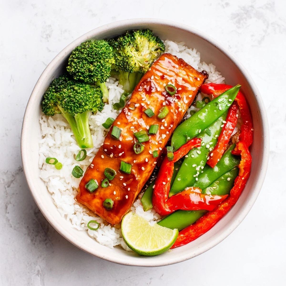Perfectly cooked Maple Soy Glazed Salmon shines in a skillet, dripping with sweet and savory sauce over crisp-tender broccoli and peppers.