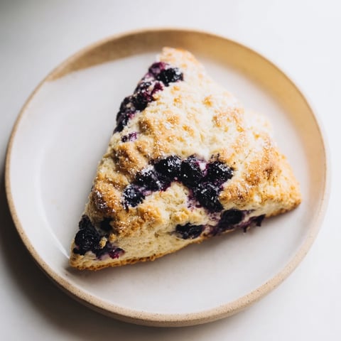 Golden-brown Rustic Birch-Warm Blueberry Scones, pictured with sugared tops, ready to serve warm for breakfast.