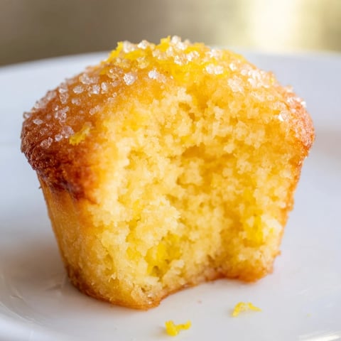 Golden brown Simple Sweet Lemon Zest Muffins, ideal for breakfast or a sweet snack after lunch.