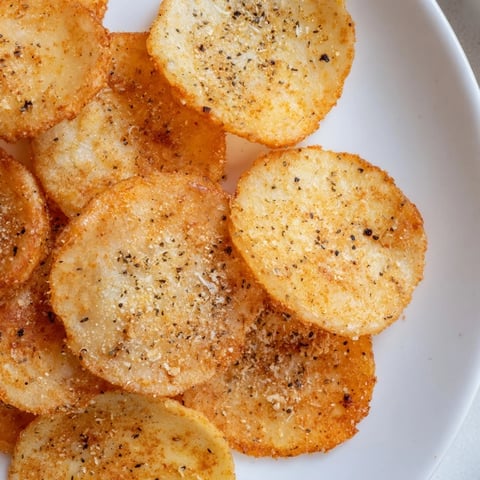 Golden-baked cottage cheese chips, seasoned with smoked paprika and garlic, arranged in a single layer on a wire rack.  