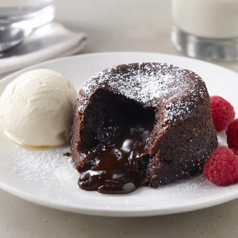 A decadent dark chocolate lava cake, served with a scoop of vanilla ice cream—a sweet treat.