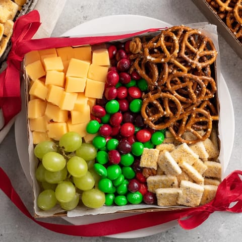 Festive Stacked Christmas Gift Snack Tower with colorful treats; a party-ready holiday appetizer.