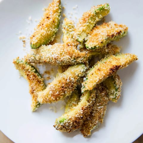 Imagine the crunchy exterior of these prepared crispy baked avocado fries—a vegetarian delight for sharing.