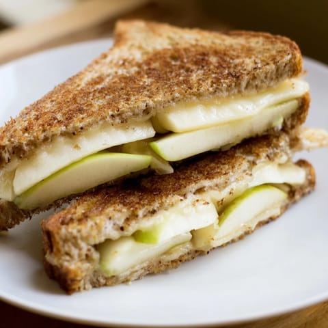 Crispy sourdough encases gooey Brie and sweet apple slices in this gourmet grilled cheese recipe.