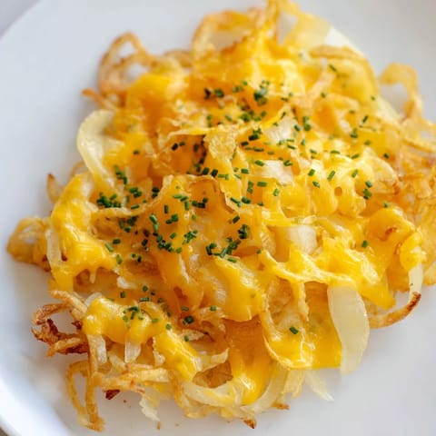 Air-fried Crispy Onion Cheese Chips, a low-carb appetizer, featuring bubbly cheese and browned onions, ready to eat.