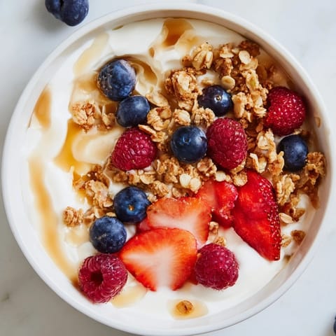 Vibrant Cottage Cheese Hot Honey Bowl: A mix of sweet berries and crunchy granola atop fresh cottage cheese.