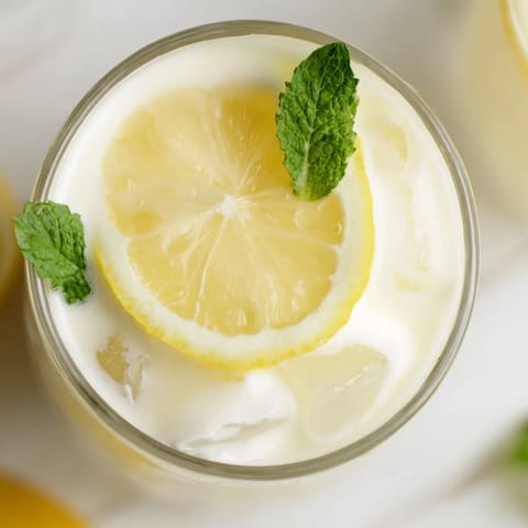 A refreshing glass of Creamy Lemonade Drink with a velvety texture and bright citrus flavor.  