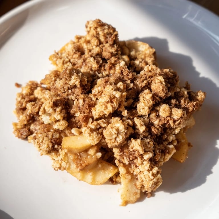 Picture of a delicious Warm Rustic Apple and Cinnamon Crumble, ready to serve, a perfect dessert for a cozy night.