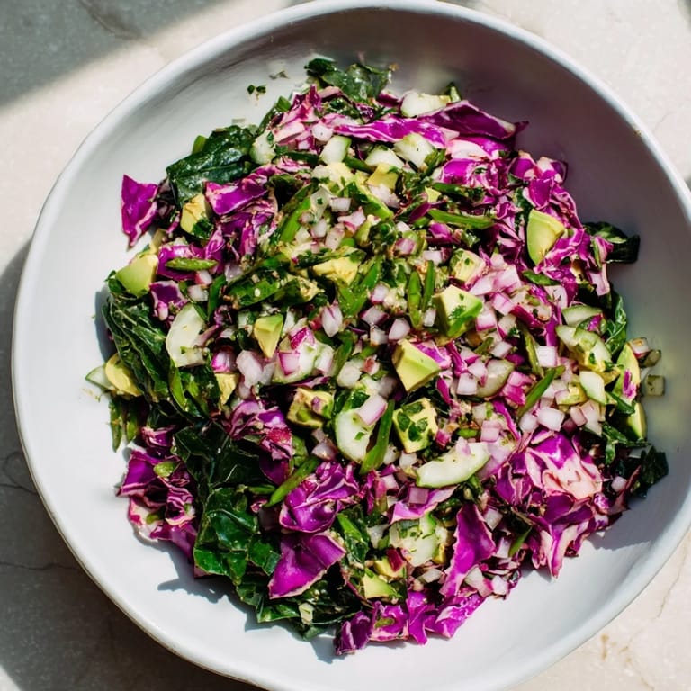 A refreshing bowl of Green Goddess Detox Cabbage Salad, bursting with colorful, fresh ingredients and flavors.