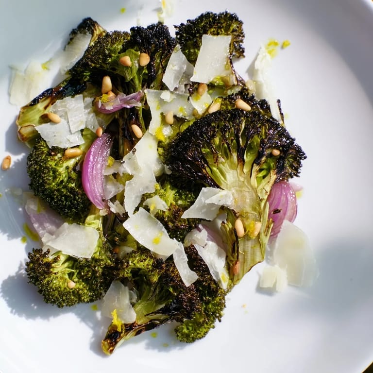 Enjoy a bowl of warm, inviting charred broccoli salad, tossed with perfect Parmesan shavings.
