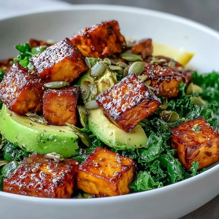 Healthy vegan breakfast bowl with seasoned tofu, fresh kale, avocado, and optional pumpkin seeds for a satisfying morning meal.